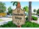 A vibrant sign marks the entrance to Southside Village Shops, framed by lush greenery and palm trees at 2516 Goldenrod St, Sarasota, FL 34239