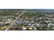 Expansive aerial view of a neighborhood with lush greenery, showcasing well-maintained homes and the coastal scenery in the background at 2715 Herwald St, Sarasota, FL 34231