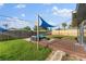 Cozy backyard seating area with shade sail on a well-maintained lawn at 2715 Herwald St, Sarasota, FL 34231