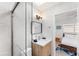 Modern bathroom with a glass shower door, marble tiles, and updated vanity at 2715 Herwald St, Sarasota, FL 34231