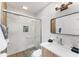Modern bathroom featuring marble tile shower, sleek fixtures, and wood-look flooring at 2715 Herwald St, Sarasota, FL 34231