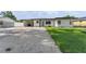 Charming single-story home with a carport and well-manicured lawn features fresh exterior paint at 2715 Herwald St, Sarasota, FL 34231