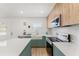 Well-designed kitchen with modern appliances, white countertops, and a farmhouse sink perfect for cooking at 2715 Herwald St, Sarasota, FL 34231