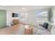Bright living room with large windows, light wood floors, and comfortable seating at 2715 Herwald St, Sarasota, FL 34231