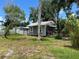 Backyard with a quaint cottage featuring mature landscaping, perfect for outdoor relaxation at 2722 9Th Ave W, Bradenton, FL 34205