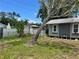 Side view of home surrounded by lush green landscaping under a sunny blue sky at 2722 9Th Ave W, Bradenton, FL 34205