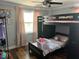Comfortable bedroom with a stylish bunk bed and large window at 2722 9Th Ave W, Bradenton, FL 34205