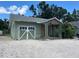 Charming home featuring a unique garage door, covered entry and mature landscaping at 2722 9Th Ave W, Bradenton, FL 34205