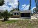 Charming home exterior with a screened porch and gravel landscaping, perfect for Florida living at 2722 9Th Ave W, Bradenton, FL 34205