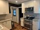 Modern kitchen with white cabinets, stainless steel appliances, and granite countertops at 2722 9Th Ave W, Bradenton, FL 34205