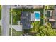 Aerial view of a well-maintained property featuring a backyard pool and lush green lawn at 2915 Woodpine Cir, Sarasota, FL 34231