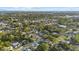 Wide aerial view showing a lush, leafy neighborhood dotted with charming homes and mature trees at 2915 Woodpine Cir, Sarasota, FL 34231