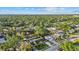 Expansive aerial view showcasing a lush neighborhood, highlighting a beautiful home with a pool and mature trees at 2915 Woodpine Cir, Sarasota, FL 34231