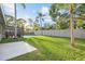 Spacious backyard with lush green grass, complemented by a pool and tropical landscaping, perfect for outdoor living at 2915 Woodpine Cir, Sarasota, FL 34231