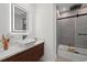 Modern bathroom boasts stylish vanity, sleek fixtures, an LED mirror, and a shower/tub with glass enclosure at 2915 Woodpine Cir, Sarasota, FL 34231