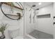 Contemporary bathroom with a glass shower featuring dual shower heads and a tiled floor at 2915 Woodpine Cir, Sarasota, FL 34231