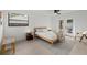 Bright bedroom featuring a wooden bed frame, backyard views, and a ceiling fan at 2915 Woodpine Cir, Sarasota, FL 34231