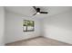 Bright, inviting bedroom with ceiling fan and ample natural light; perfect for relaxation and comfort at 2915 Woodpine Cir, Sarasota, FL 34231