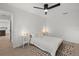 Well-lit bedroom with a ceiling fan, a plush bed, and modern interior design elements for restful relaxation at 2915 Woodpine Cir, Sarasota, FL 34231