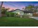 Inviting single-story home featuring manicured lawn, lush green shrubs, and attractive landscaping at 2915 Woodpine Cir, Sarasota, FL 34231