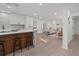 Open kitchen with white cabinets, a wood-accented island with seating, and recessed lighting at 2915 Woodpine Cir, Sarasota, FL 34231