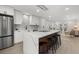 Open concept kitchen featuring a large island with seating and stainless steel appliances at 2915 Woodpine Cir, Sarasota, FL 34231