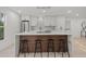Beautiful kitchen with white cabinets, a wood-accented island with seating, and modern fixtures at 2915 Woodpine Cir, Sarasota, FL 34231
