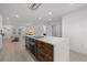 Modern kitchen featuring an island with wood accents and stainless appliances and an open floorplan at 2915 Woodpine Cir, Sarasota, FL 34231