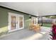 Enclosed patio with a dining area and views of the backyard and landscaping, ideal for relaxation and entertainment at 2915 Woodpine Cir, Sarasota, FL 34231