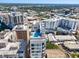 High-angle view of a building with a rooftop pool and seating area amid the urban landscape at 33 S Palm Ave # 1202, Sarasota, FL 34236