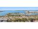 Balcony view of a waterfront area with a marina filled with boats and a city skyline in the distance at 33 S Palm Ave # 1202, Sarasota, FL 34236