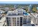 Aerial view of a multi-story building with a rooftop pool and a city view at 33 S Palm Ave # 1202, Sarasota, FL 34236