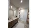 Contemporary bathroom with double vanity, stylish mirrors, and a minimalist shelving unit at 33 S Palm Ave # 1202, Sarasota, FL 34236