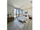 Serene bedroom with large windows offering city views and stylish furnishings at 33 S Palm Ave # 1202, Sarasota, FL 34236