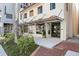 The building has modern entrance with glass windows, brick accents, and landscaping enhancing its curb appeal at 33 S Palm Ave # 1202, Sarasota, FL 34236