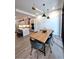 Open-concept dining area featuring a wooden table, comfortable seating, and modern light fixtures at 33 S Palm Ave # 1202, Sarasota, FL 34236
