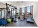 Bright gym features a ceiling fan, fitness machines, weights, rubber floor, and large windows with neighborhood views at 33 S Palm Ave # 1202, Sarasota, FL 34236