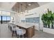 Long kitchen island with seating, pendant lighting, modern appliances, and stylish backsplash at 33 S Palm Ave # 1202, Sarasota, FL 34236