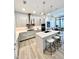 Bright kitchen featuring an island with seating, modern appliances, sleek countertops, and a view of the dining area at 33 S Palm Ave # 1202, Sarasota, FL 34236