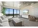 Living room with large windows providing views, comfortable seating, and a modern entertainment setup at 33 S Palm Ave # 1202, Sarasota, FL 34236
