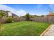 Lush backyard features green grass, wood fencing for privacy, and mature trees adding to the outdoor appeal at 3910 77Th E Pl, Sarasota, FL 34243