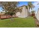 Well-maintained backyard with lush lawn, wooden deck, and mature shade trees at 3910 77Th E Pl, Sarasota, FL 34243
