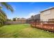 Backyard featuring mature trees, a wooden deck, and screened-in lanai at 3910 77Th E Pl, Sarasota, FL 34243
