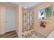 Bright bathroom featuring patterned shower curtain and tiled floor at 3910 77Th E Pl, Sarasota, FL 34243
