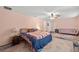 Spacious bedroom with cozy seating area, ceiling fan, and soft color palette at 3910 77Th E Pl, Sarasota, FL 34243