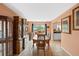 Elegant dining room with a large china cabinet and sliding door access to outdoor space at 3910 77Th E Pl, Sarasota, FL 34243