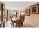 Cozy dining room with tile floors, a view to the backyard, and kitchen access through the opening at 3910 77Th E Pl, Sarasota, FL 34243