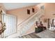 Bright entryway featuring a staircase with white railing, leading to the second floor of the home at 3910 77Th E Pl, Sarasota, FL 34243