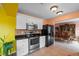 Bright kitchen features stainless steel appliances, black countertops, and white cabinetry at 3910 77Th E Pl, Sarasota, FL 34243