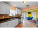 Bright kitchen features white cabinets, stainless steel appliances, and a sink with a view at 3910 77Th E Pl, Sarasota, FL 34243